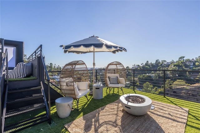 view of patio / terrace featuring a balcony and a fire pit