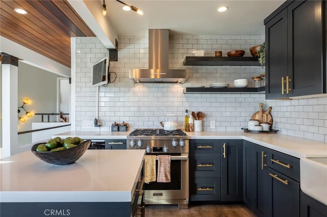 kitchen with high end range, backsplash, and wall chimney range hood