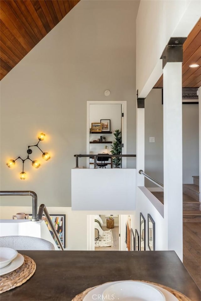 dining space with wood-type flooring, high vaulted ceiling, and wood ceiling