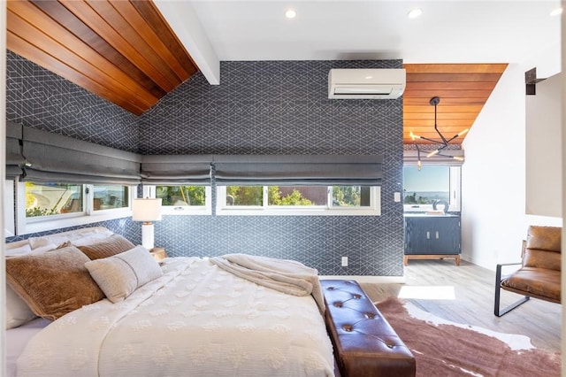 bedroom featuring a wall mounted AC, light hardwood / wood-style floors, and vaulted ceiling with beams