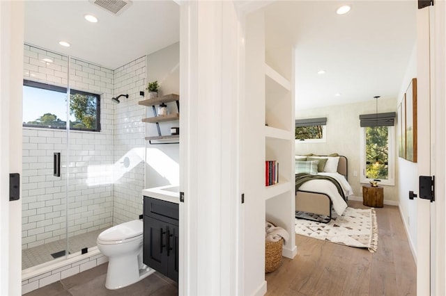 bathroom featuring hardwood / wood-style floors, vanity, toilet, and a healthy amount of sunlight