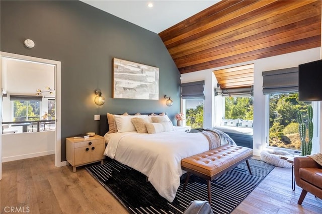 bedroom with light hardwood / wood-style flooring, wooden ceiling, and vaulted ceiling