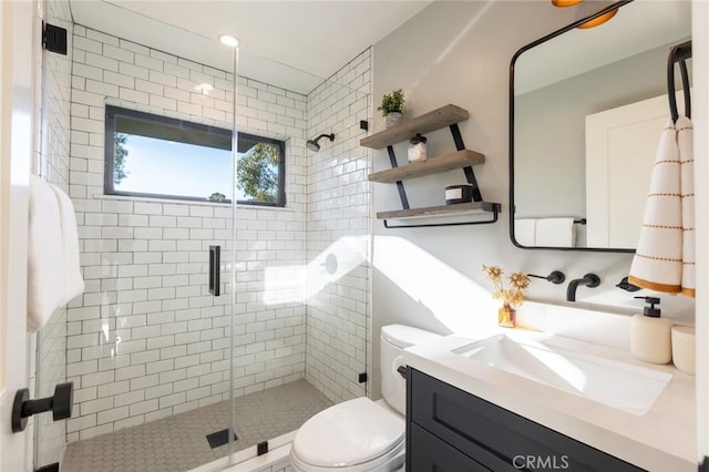 bathroom featuring vanity, toilet, and walk in shower