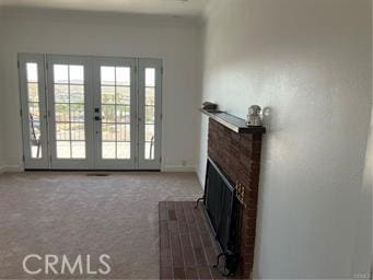 10 Hilltop, Barstow, CA 92311 - living room featuring a brick fireplace, french doors, baseboards, and carpet floors