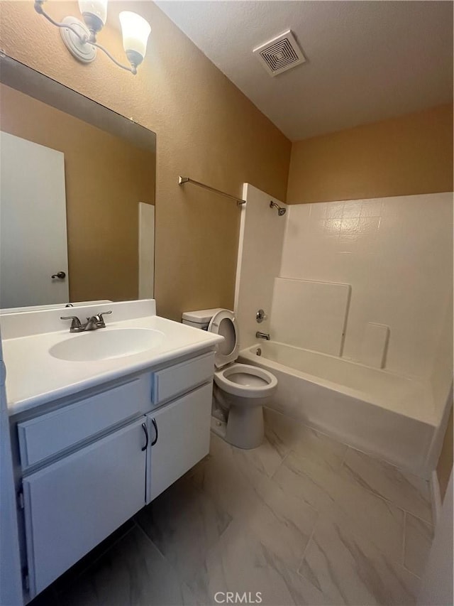 full bathroom featuring vanity, bathtub / shower combination, and toilet