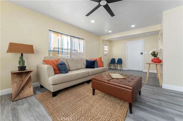 living room featuring ceiling fan and wood-type flooring