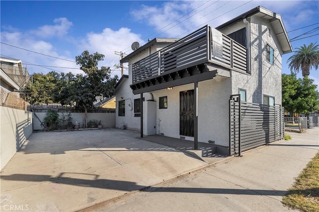 view of front of home featuring a patio area and a balcony