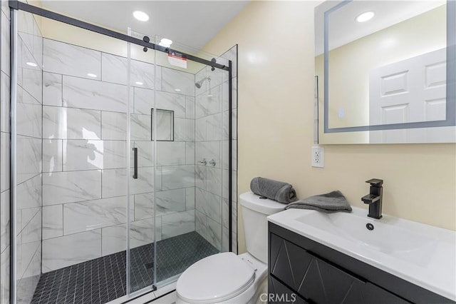 bathroom featuring vanity, toilet, and walk in shower