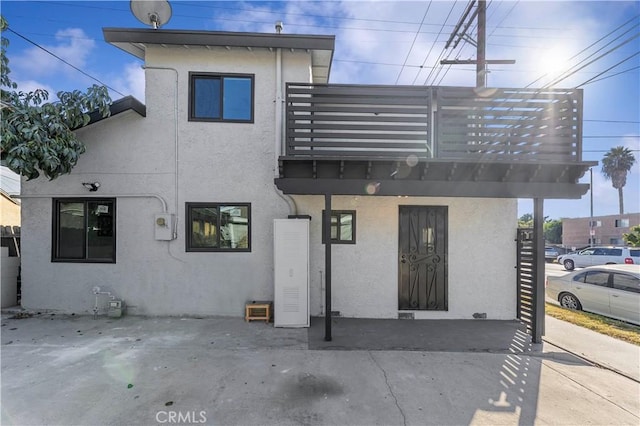 back of house with a balcony