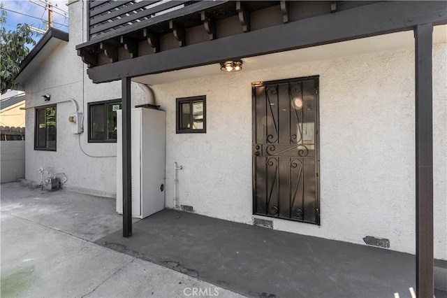 property entrance with a patio area