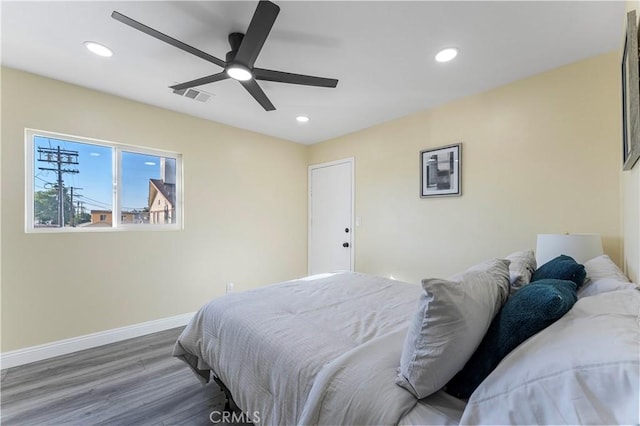 bedroom with ceiling fan and hardwood / wood-style floors