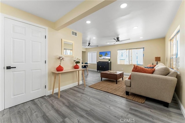 living room featuring light wood-type flooring and ceiling fan