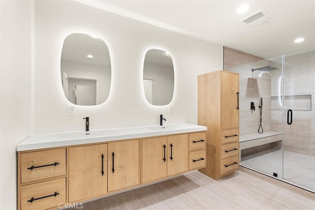 bathroom featuring vanity and an enclosed shower