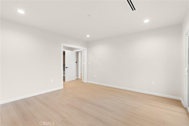 spare room with light wood-type flooring