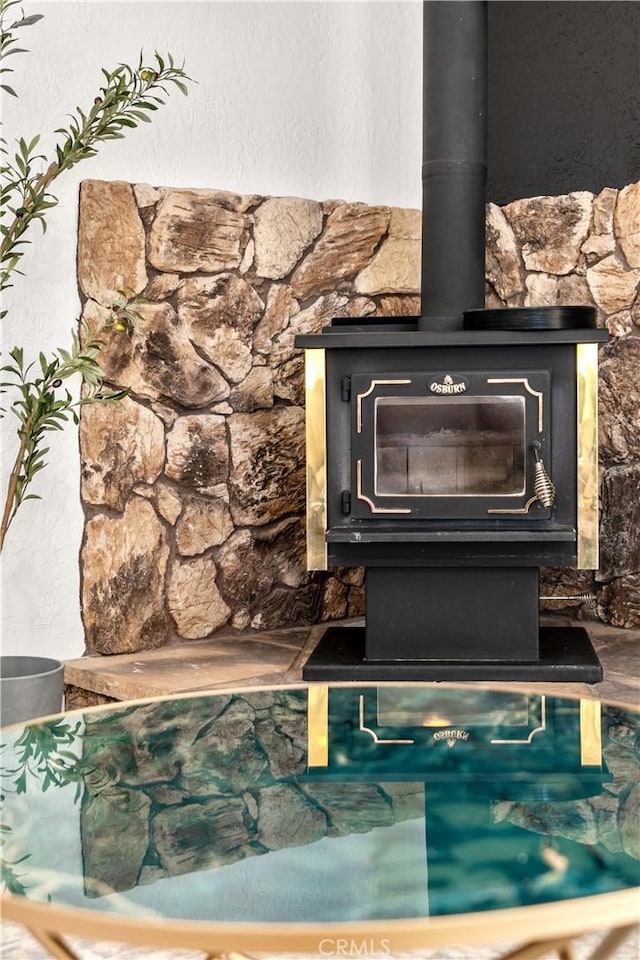 room details featuring backsplash and a wood stove