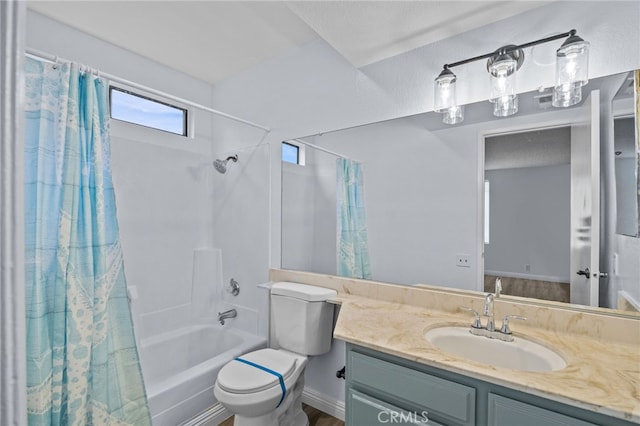 full bathroom featuring toilet, vanity, and shower / bathtub combination with curtain