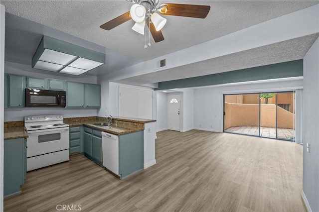 kitchen with ceiling fan, light wood-type flooring, sink, and white appliances