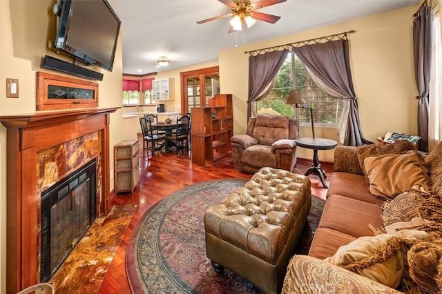 living room with ceiling fan, dark hardwood / wood-style flooring, and a fireplace