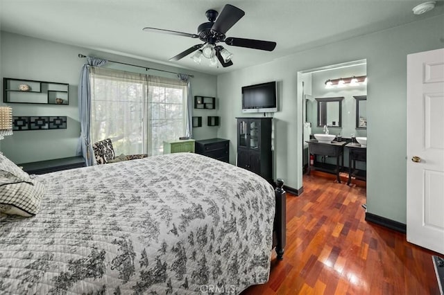 bedroom with ceiling fan, dark wood-type flooring, and ensuite bathroom