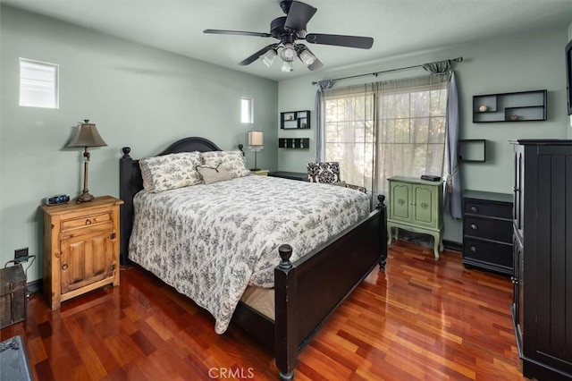 bedroom featuring ceiling fan and dark hardwood / wood-style floors