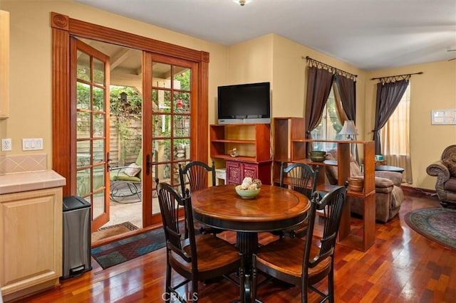 dining room with dark wood-type flooring and french doors