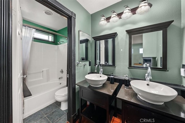 full bathroom featuring toilet, vanity, and shower / bathtub combination with curtain