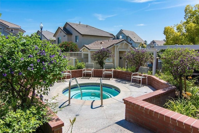 view of swimming pool featuring a patio and an in ground hot tub