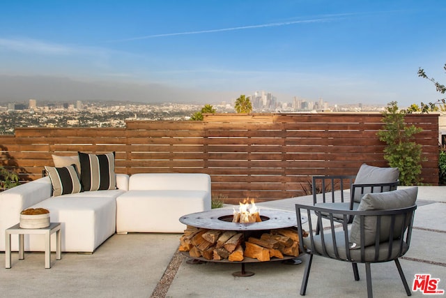 view of patio featuring an outdoor living space with a fire pit