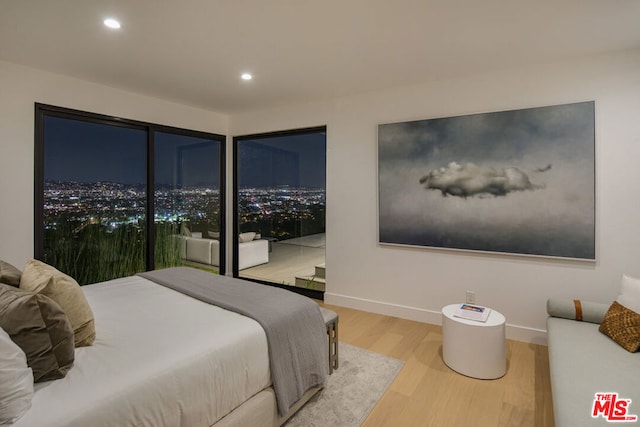 bedroom featuring access to outside and light hardwood / wood-style floors