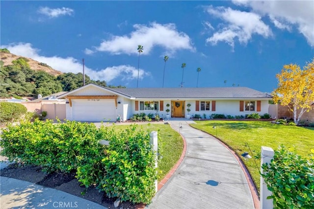 ranch-style home with a front yard and a garage