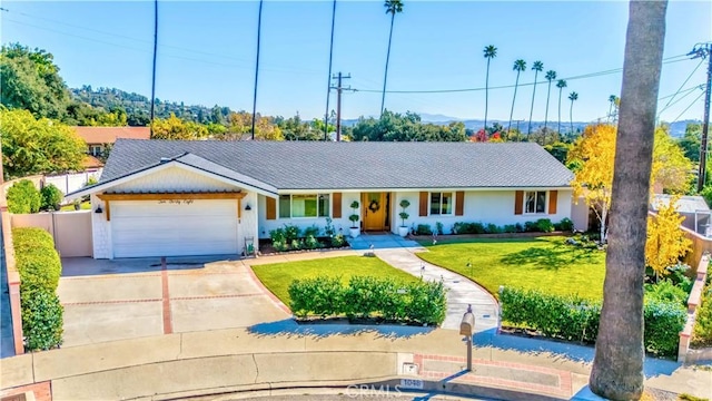 ranch-style home with a front yard and a garage