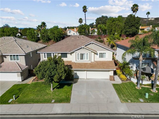 view of front of property featuring a garage and a front lawn