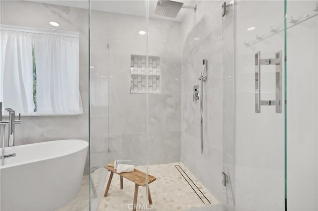 bathroom with tile walls and plus walk in shower