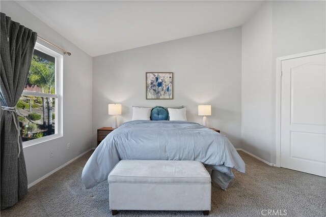 bedroom with light carpet and lofted ceiling