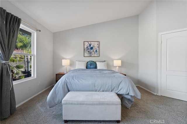 bedroom with lofted ceiling and carpet