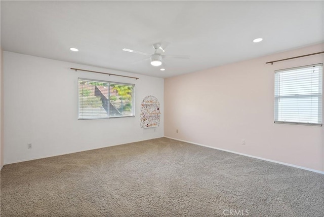 carpeted empty room featuring ceiling fan