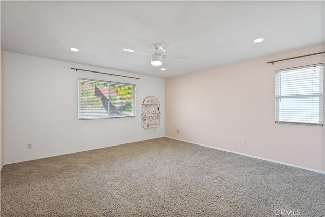 carpeted empty room featuring ceiling fan