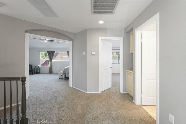 hallway featuring light carpet