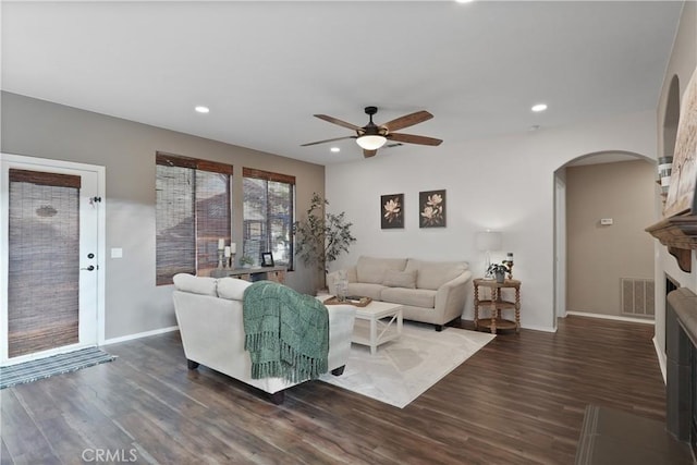 living room with ceiling fan and dark hardwood / wood-style floors