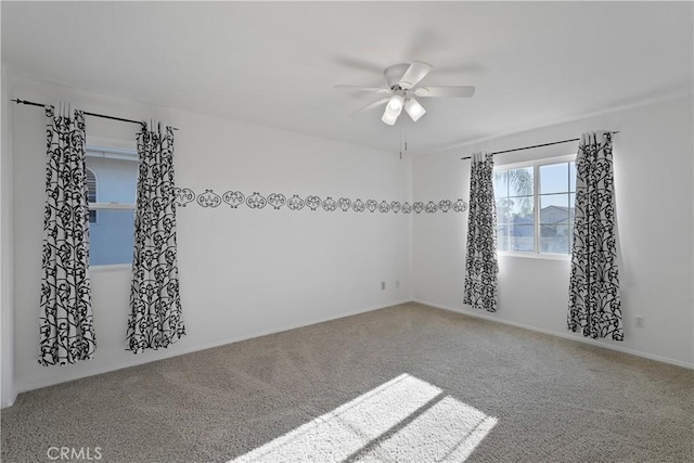 unfurnished room with ceiling fan and carpet floors