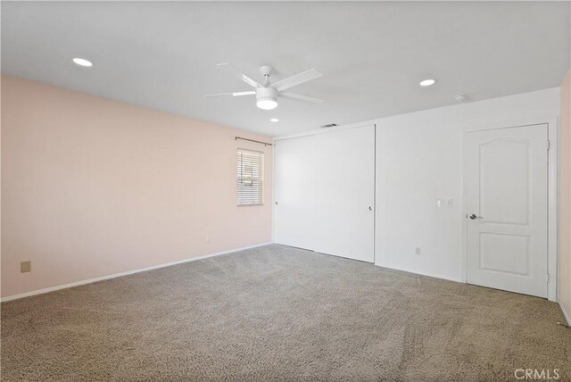 carpeted empty room with ceiling fan