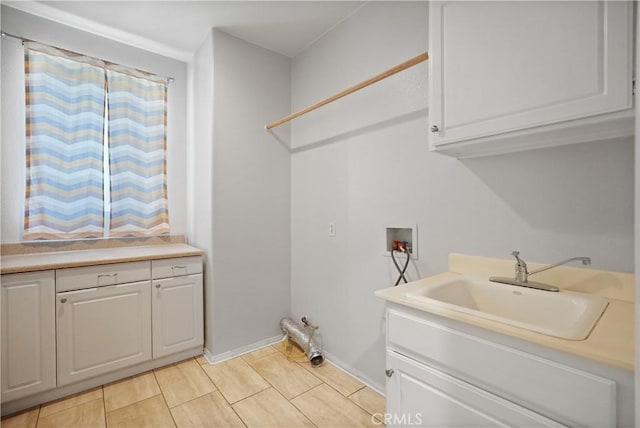 laundry room with washer hookup, cabinets, and sink