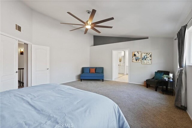 bedroom with light carpet, ensuite bath, ceiling fan, and lofted ceiling