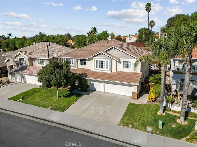 view of front of home featuring a front yard and a garage