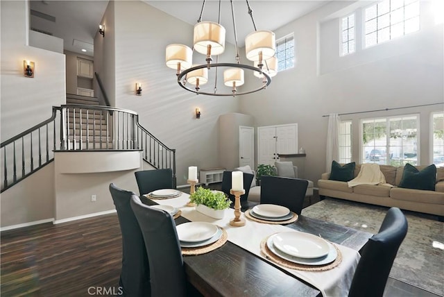 dining room featuring plenty of natural light, dark wood-type flooring, and a high ceiling