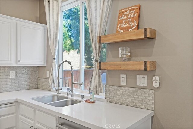 kitchen featuring white cabinetry, a healthy amount of sunlight, and sink