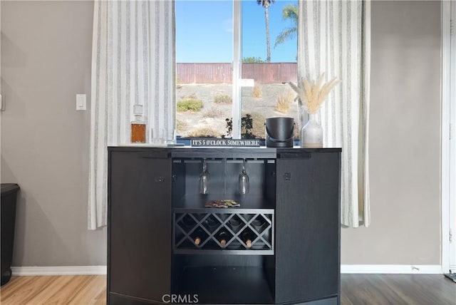 details with bar area and hardwood / wood-style floors