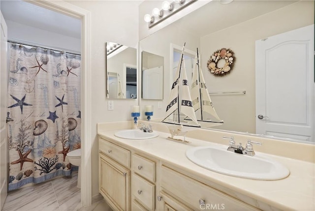 bathroom featuring vanity, curtained shower, and toilet