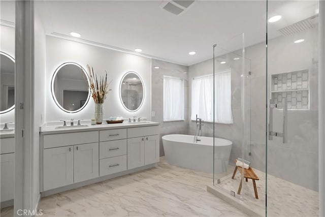 bathroom with vanity and separate shower and tub