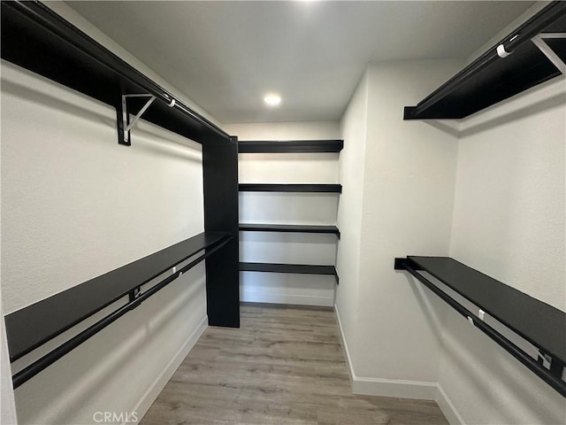 walk in closet featuring light hardwood / wood-style floors